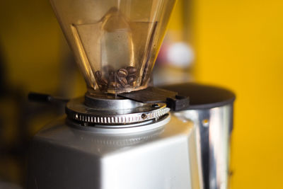 Close-up of coffee beans in machine.