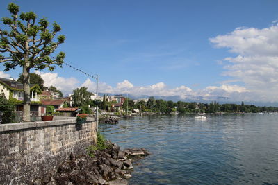 Scenic view of lake by building against sky