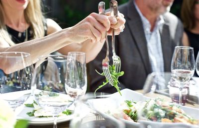 Cropped image of woman having food in restaurant