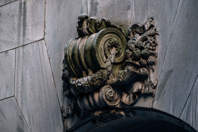 Low angle view of old sculpture on wall