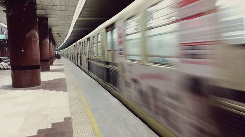 Blurred motion of train at railroad station