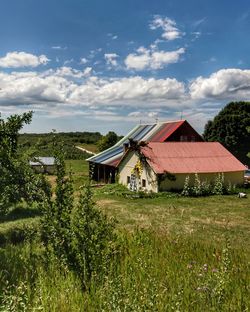 Houses on field against sky