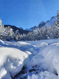 Scenic view of snowcapped mountains against blue sky