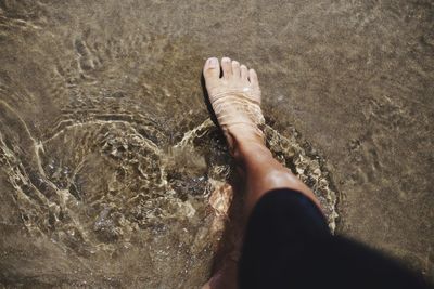 Low section of woman in water