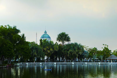 Panoramic view of trees and building against sky