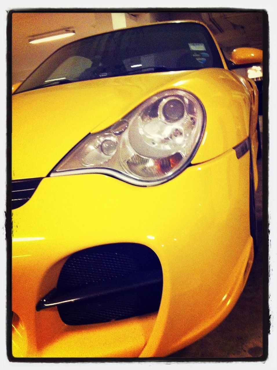 yellow, transfer print, close-up, auto post production filter, car, glass - material, high angle view, part of, reflection, land vehicle, still life, no people, mode of transport, transparent, transportation, orange color, indoors, day, shiny, metal