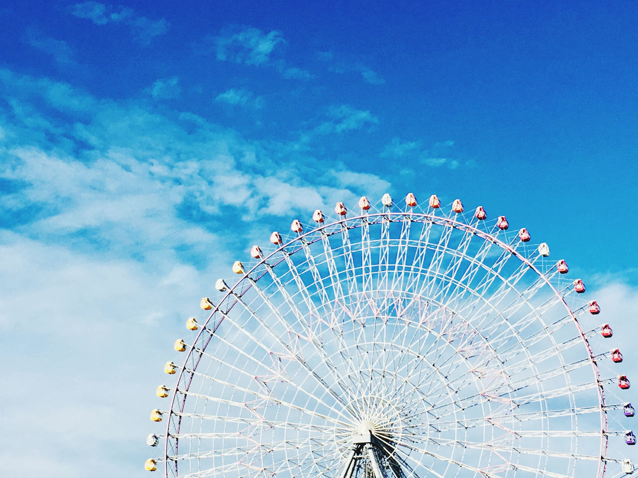 amusement park ride, amusement park, ferris wheel, sky, arts culture and entertainment, low angle view, cloud - sky, no people, nature, blue, day, shape, geometric shape, circle, outdoors, carnival, pattern, architecture, large, semi-circle, fairground