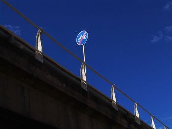 Low angle view of road sign on bridge