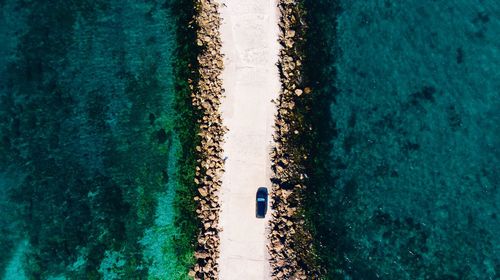 Aerial view of road amidst sea