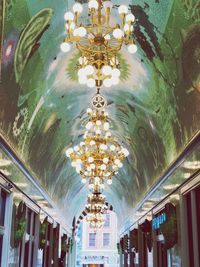 Low angle view of illuminated chandelier in building