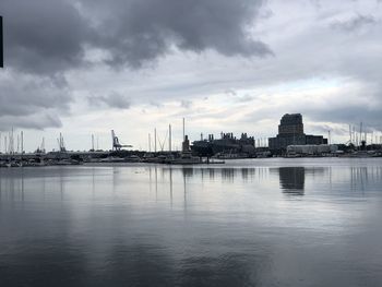 Harbor by sea against sky in city