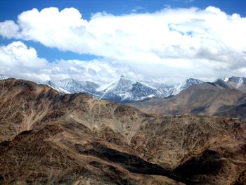 Scenic view of mountains against cloudy sky