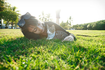 Portrait of man lying on grassy field