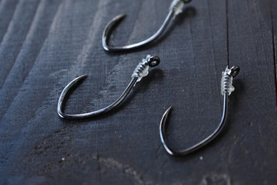 High angle view of fishing hooks on table