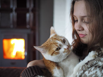 Close-up of young woman with cat