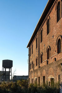 Low angle view of building against clear blue sky