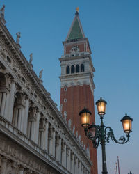 Low angle view of illuminated building against sky