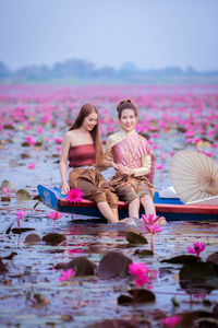 Full length of woman with pink flowers