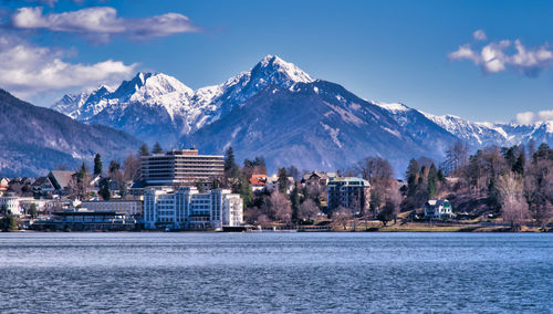 Scenic view of sea by buildings against sky