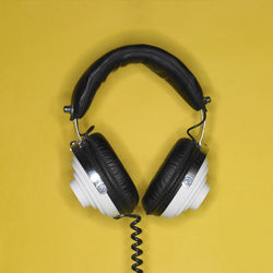 Directly above shot of headphones on red background