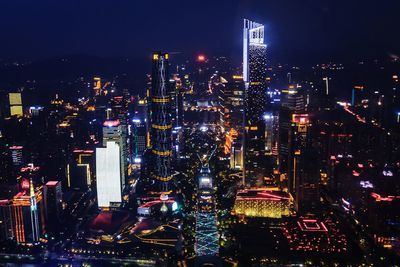 Illuminated cityscape against sky at night