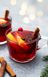 Two cups of christmas mulled wine on rustic table top view.