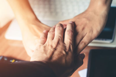 Cropped image of people stacking hands