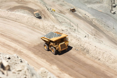 Huge dump trucks loaded with mineral in a copper mine in chile.