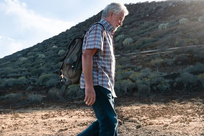 Rear view of man standing on land