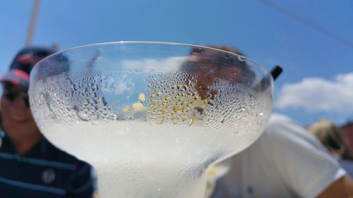 Close-up of condensed cocktail glass on sunny day