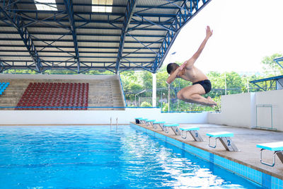 Man jumping in swimming pool