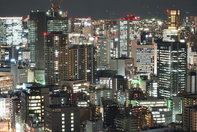 High angle view of illuminated buildings in city at night