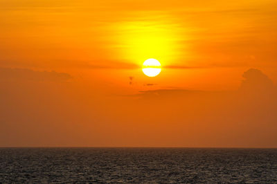 Scenic view of sea against orange sky