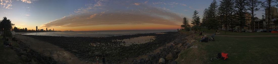 Panoramic shot of calm beach at sunset