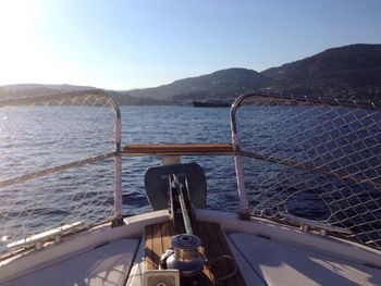 Boat sailing on sea against clear sky