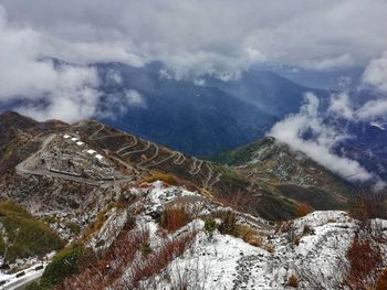 High angle view of snowcapped mountains against sky
