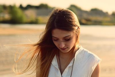 Beautiful woman with tousled hair at beach