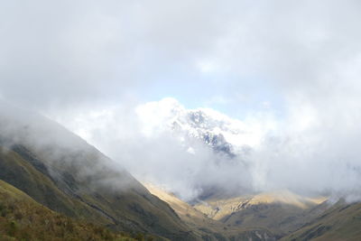 Scenic view of foggy mountain range