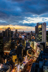 High angle view of illuminated cityscape against sky during sunset