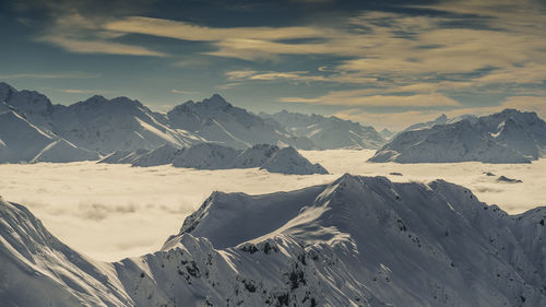 Scenic view of snowcapped mountains against sky