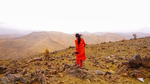 Man standing on mountain against sky