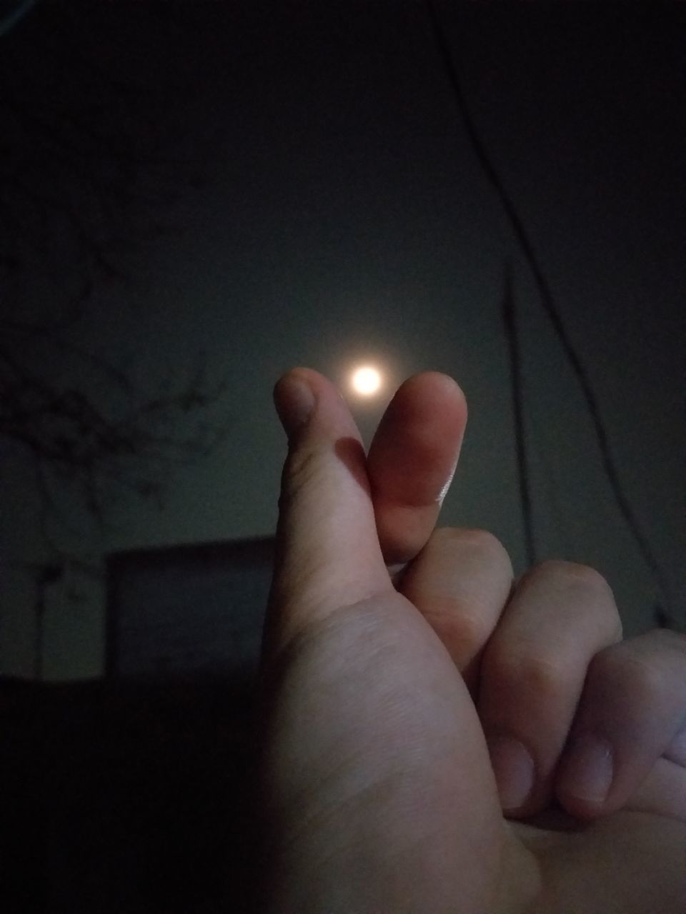CLOSE-UP OF PERSON HAND HOLDING ILLUMINATED LAMP
