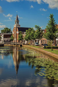 Canal with bascule bridge, church and townhouses in weesp. a pleasant small village in netherlands.