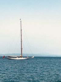 Sailboat sailing on sea against sky