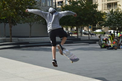 Woman jumping on road