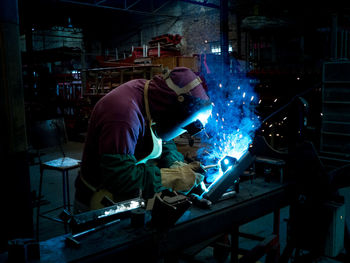 Side view of man working in factory