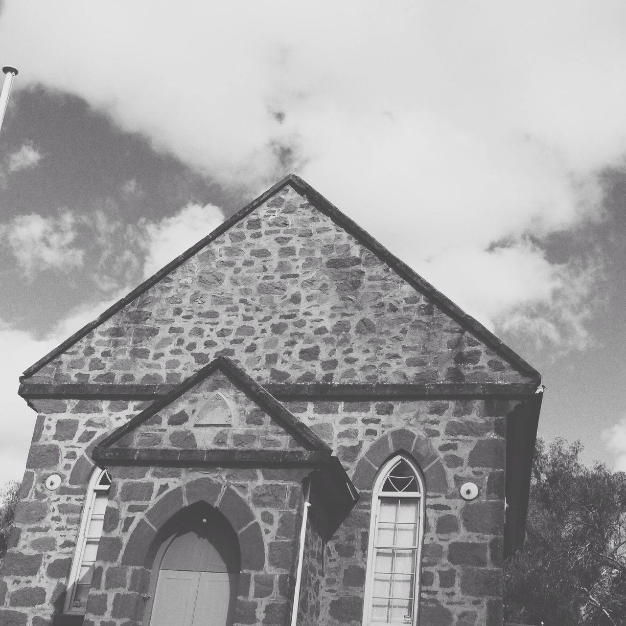 architecture, low angle view, building exterior, built structure, sky, church, religion, place of worship, spirituality, window, high section, cloud - sky, cross, day, outdoors, no people, old, history