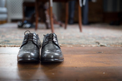 Close-up of black shoes on hardwood floor