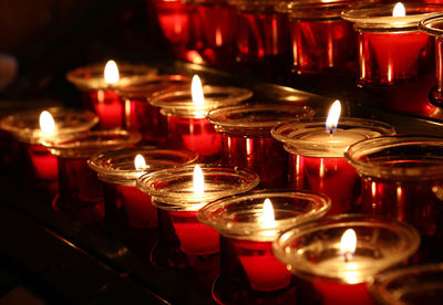 Close-up of tea light candles in temple