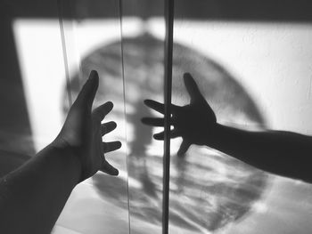 Shadow of person hand on glass window